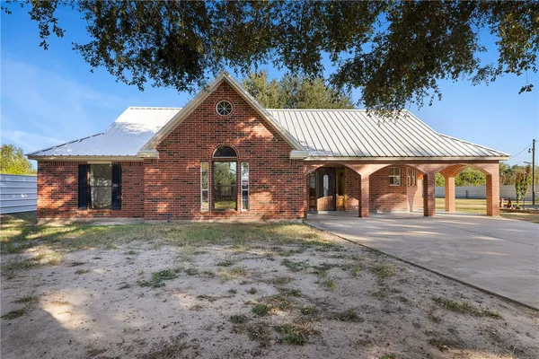 a front view of a house with garden