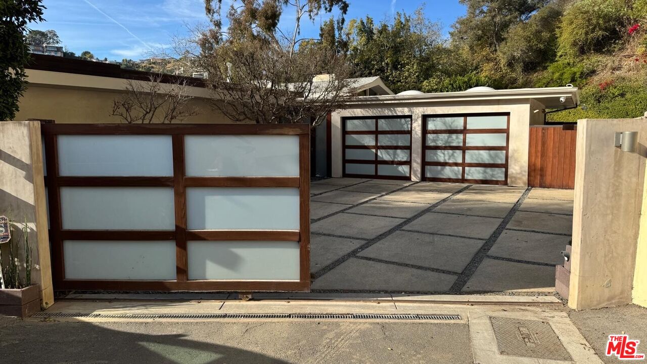 10553 Rocca Place Los Angeles, CA 90077 - Photo 1 of 1 a front view of a house with a yard