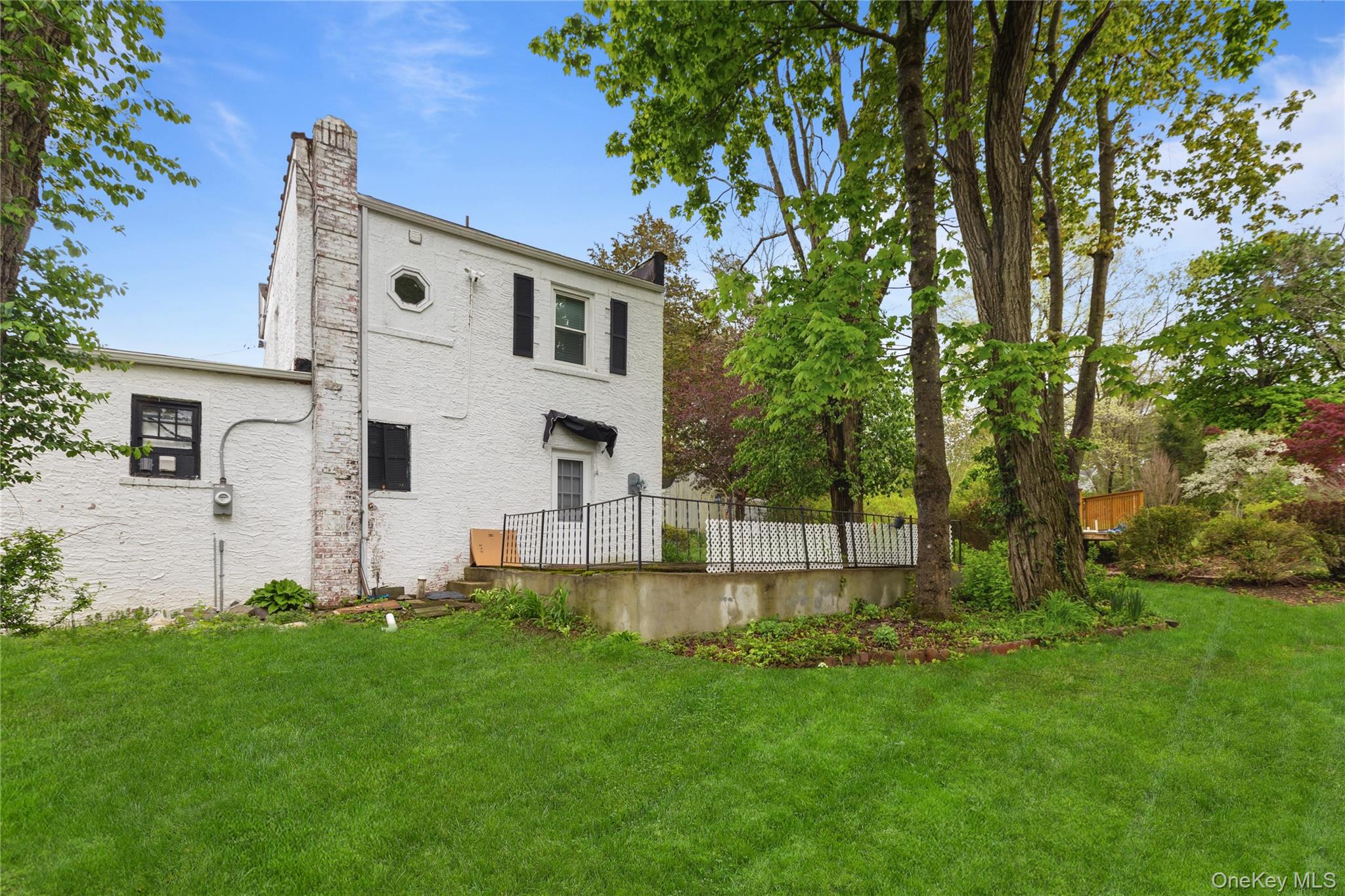 25 West Branch Road Mahopac, NY 10541 - Photo 16 of 21 a view of a white house with a big yard and large trees
