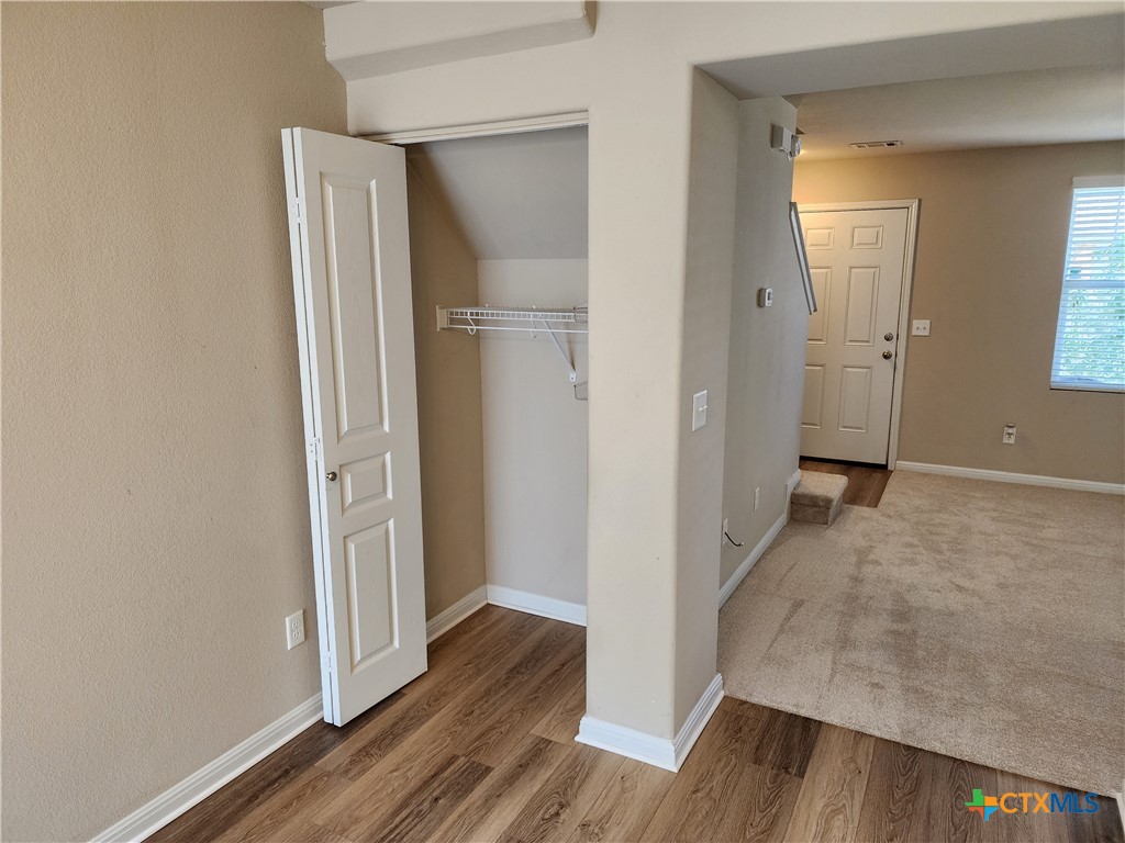 330 Trestle Tree, Unit 22 San Marcos, TX 78666 - Photo 11 of 33 a view of a hallway with wooden floor