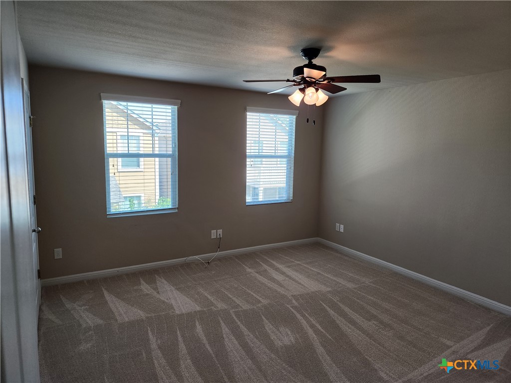330 Trestle Tree, Unit 22 San Marcos, TX 78666 - Photo 19 of 33 a view of wooden floor and a chandelier fan in a room