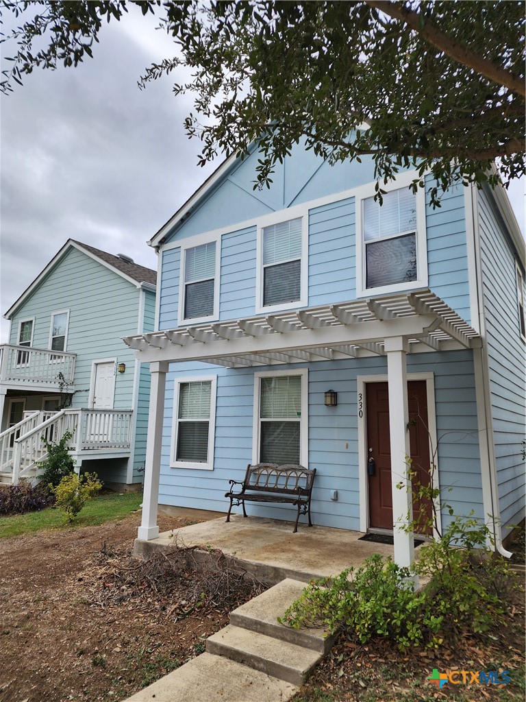 330 Trestle Tree, Unit 22 San Marcos, TX 78666 - Photo 2 of 33 a front view of a house with a yard