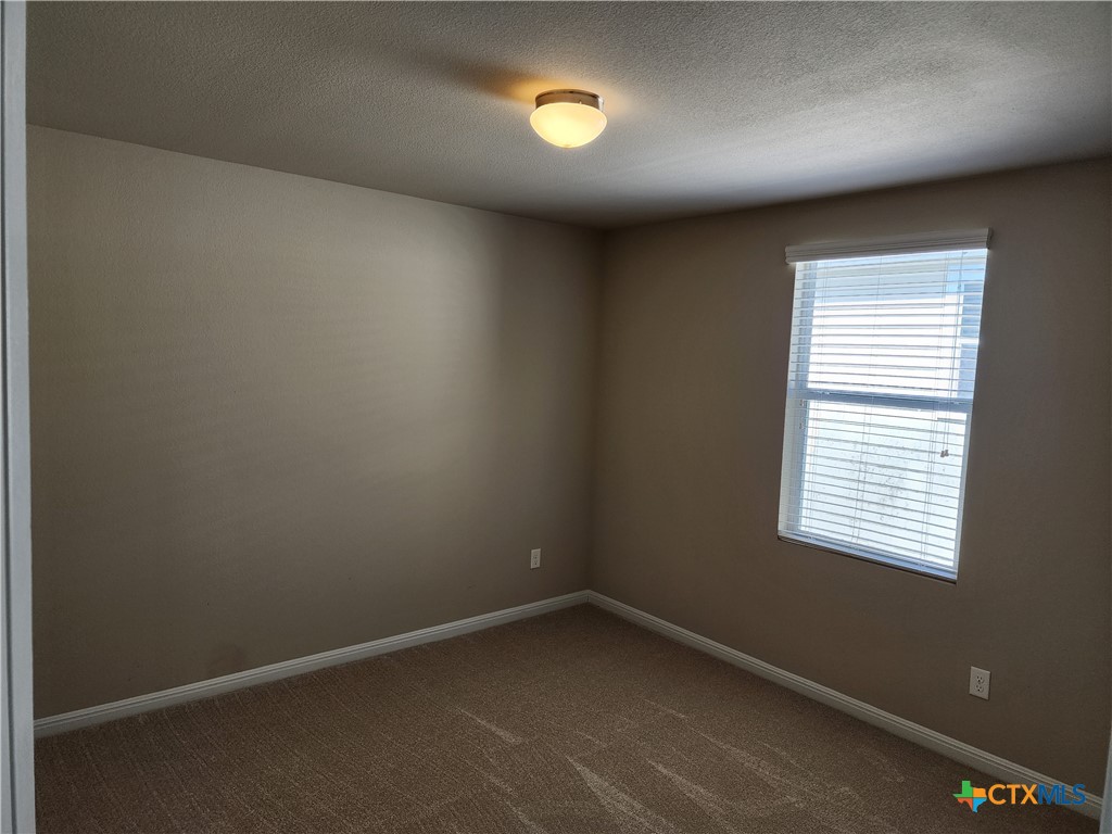 330 Trestle Tree, Unit 22 San Marcos, TX 78666 - Photo 24 of 33 a view of an empty room with a window
