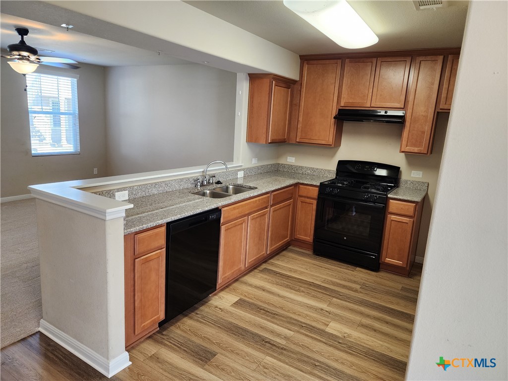 330 Trestle Tree, Unit 22 San Marcos, TX 78666 - Photo 6 of 33 a kitchen with stainless steel appliances granite countertop a stove a sink dishwasher and a refrigerator