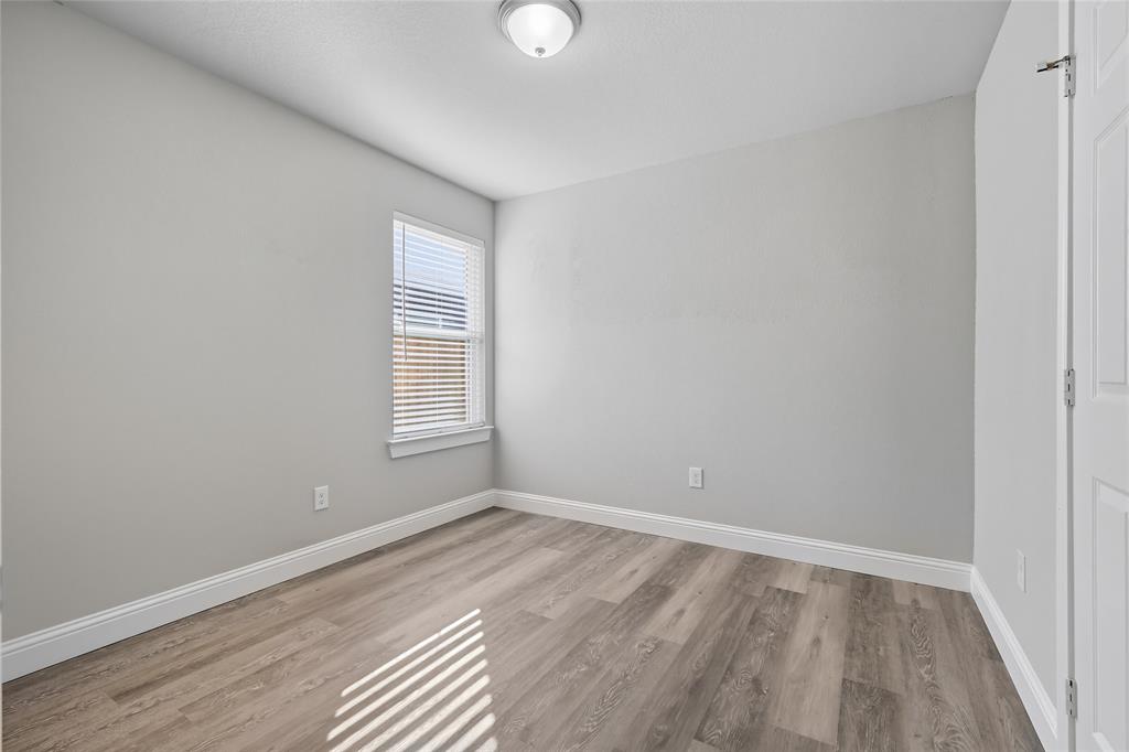 3151 Stag Road Dallas, TX 75241 - Photo 15 of 19 a view of an empty room with wooden floor and a window