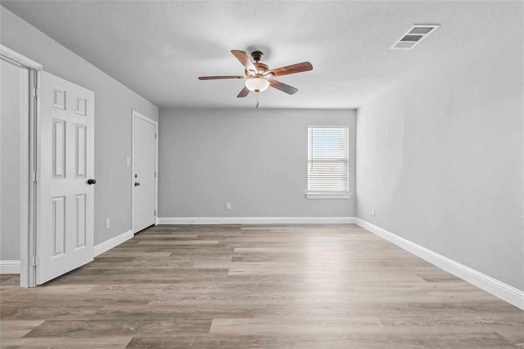 3151 Stag Road Dallas, TX 75241 - Photo 7 of 19 a view of empty room with wooden floor and fan