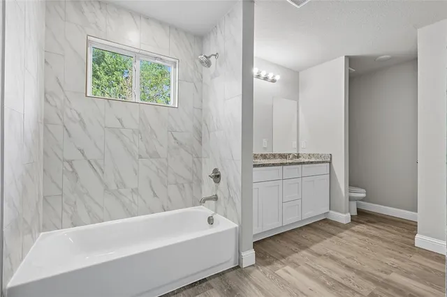 a bathroom with a bathtub and a shower
