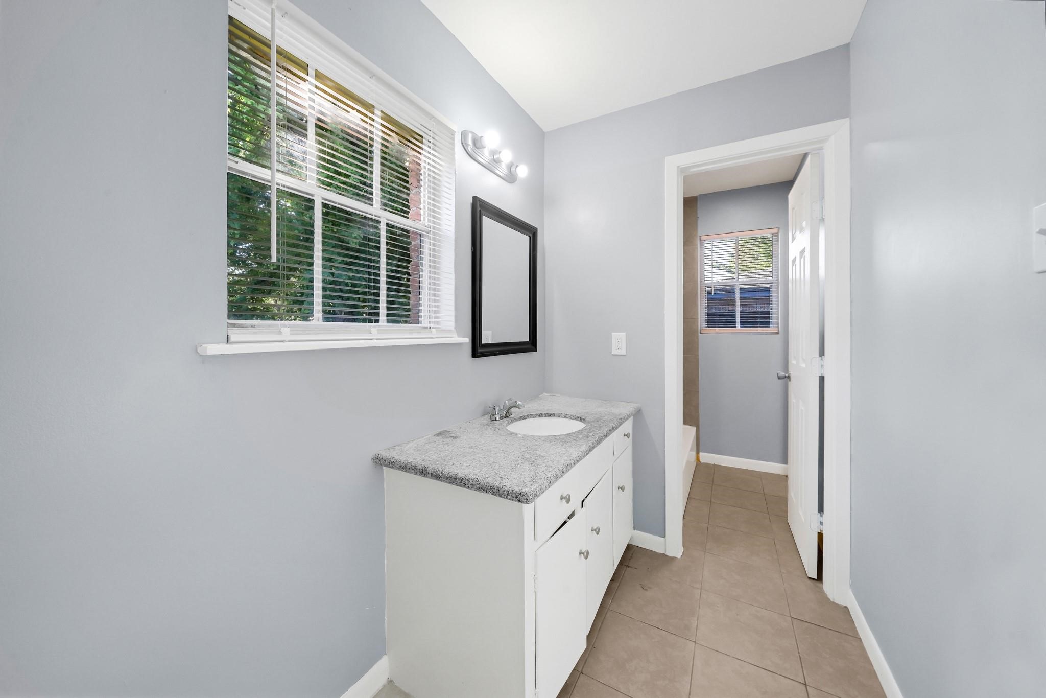 11202 Waxwing Street Houston, TX 77035 - Photo 13 of 19 a bathroom with a sink a vanity and a mirror