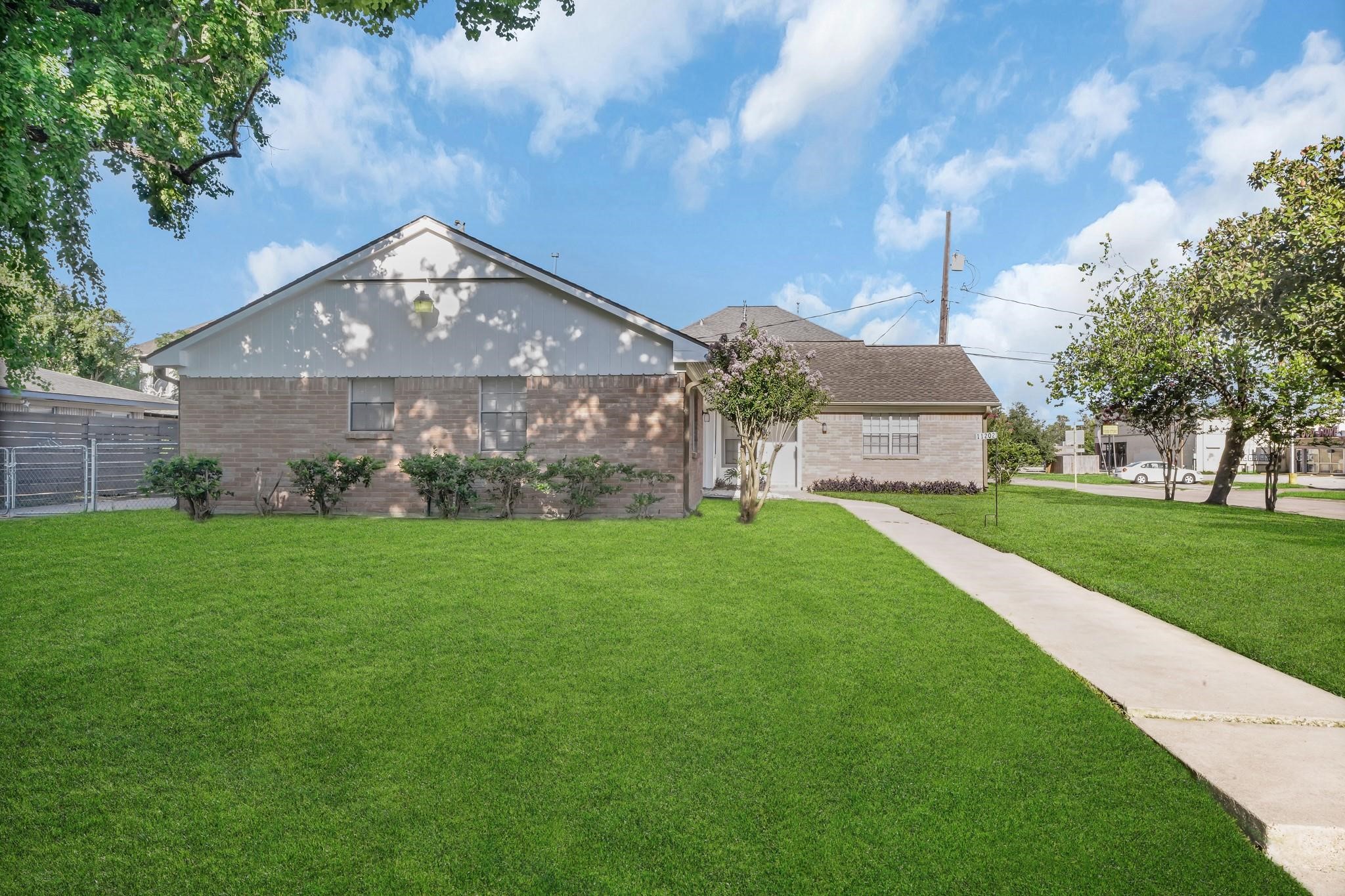 11202 Waxwing Street Houston, TX 77035 - Photo 15 of 19 a front view of a house with garden