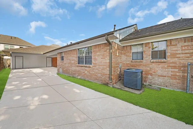 a backyard of a house with table and chairs