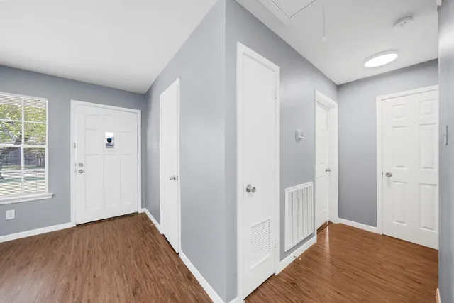 a view of hallway with wooden floor