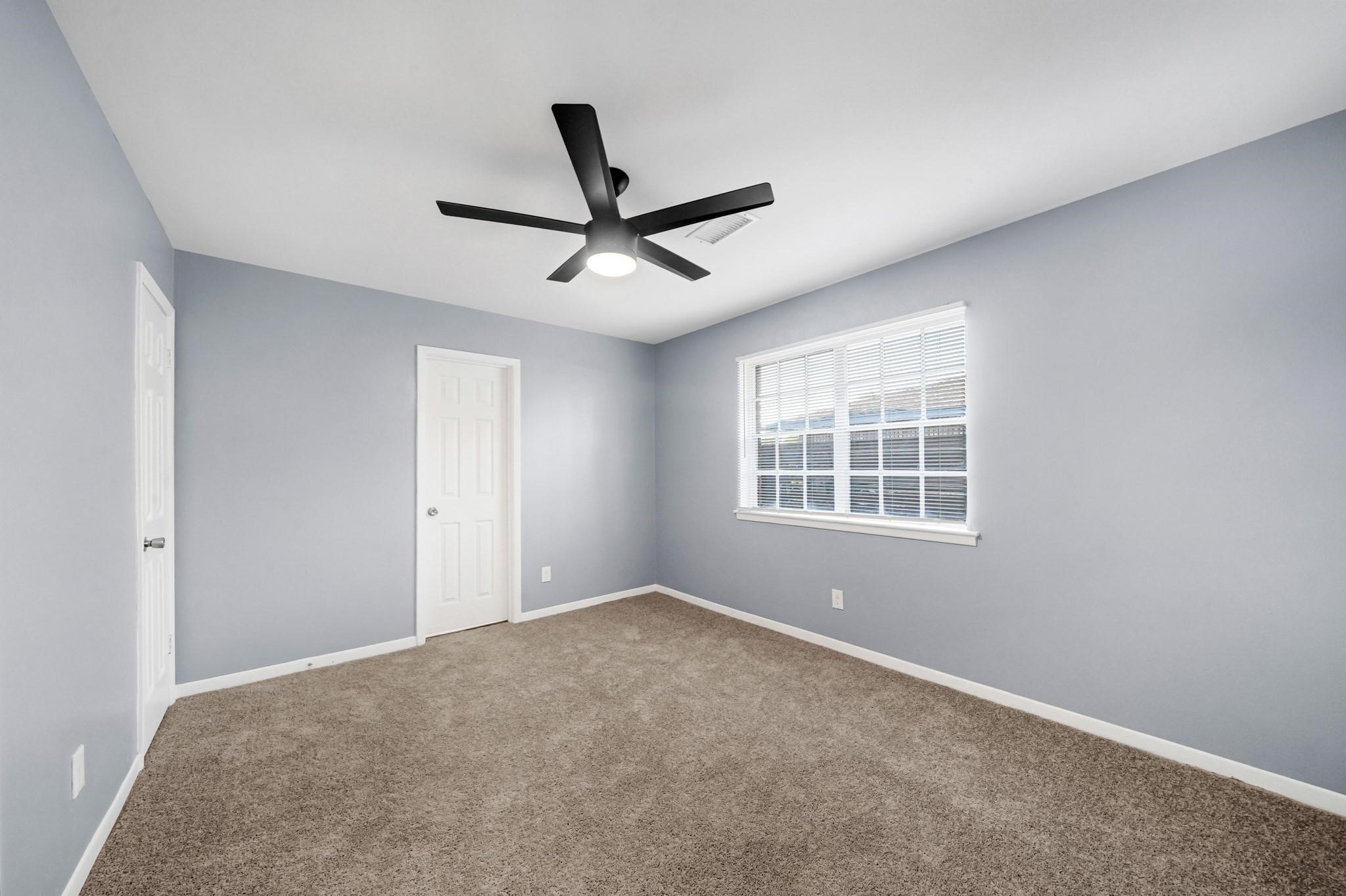 11202 Waxwing Street Houston, TX 77035 - Photo 10 of 19 a view of a big room with windows and ceiling fan