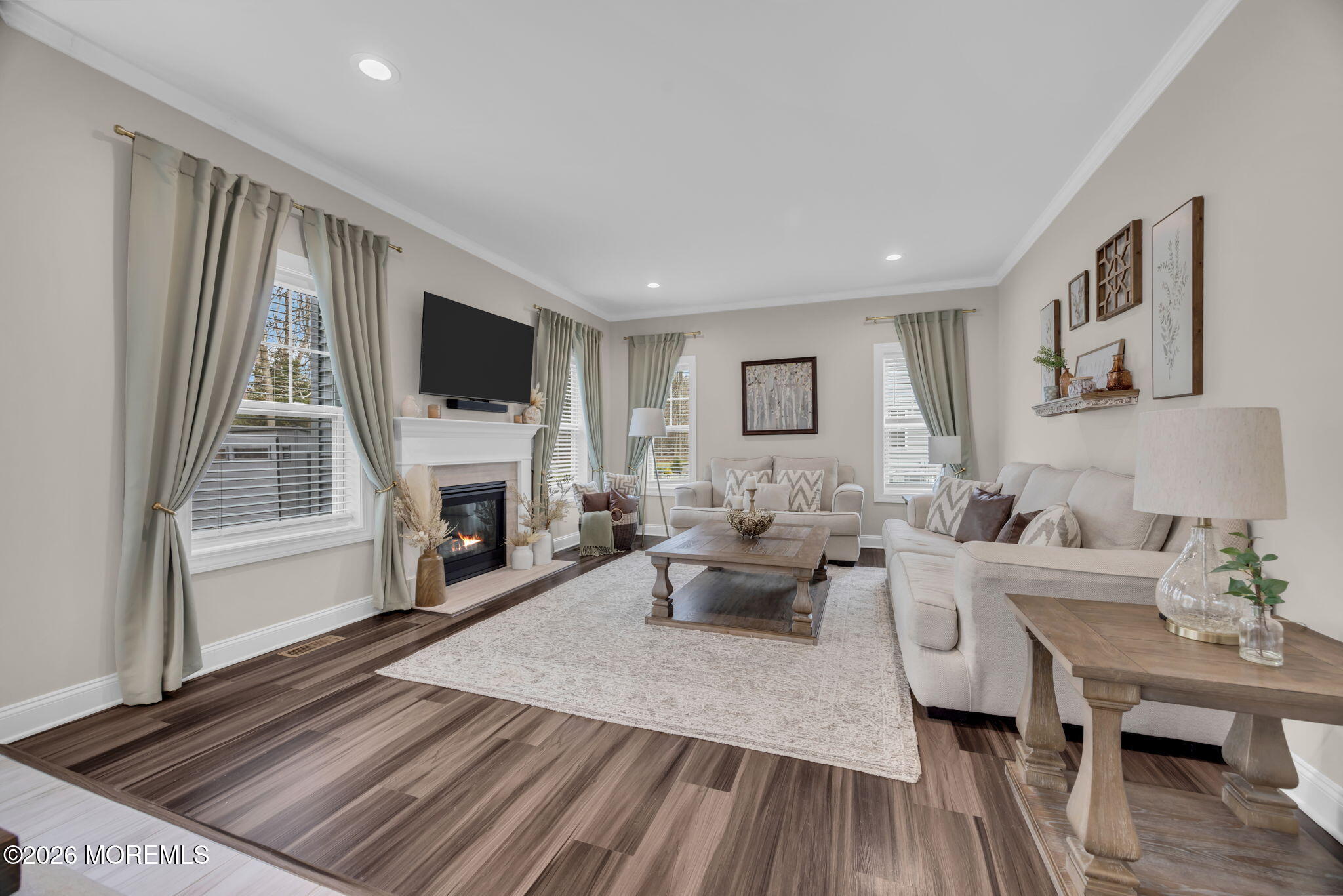 10 Tasha Lane Howell, NJ 07731 - Photo 14 of 44 a living room with furniture a fireplace and a flat screen tv