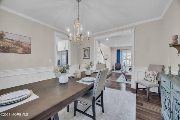 a view of a dining room with furniture and chandelier