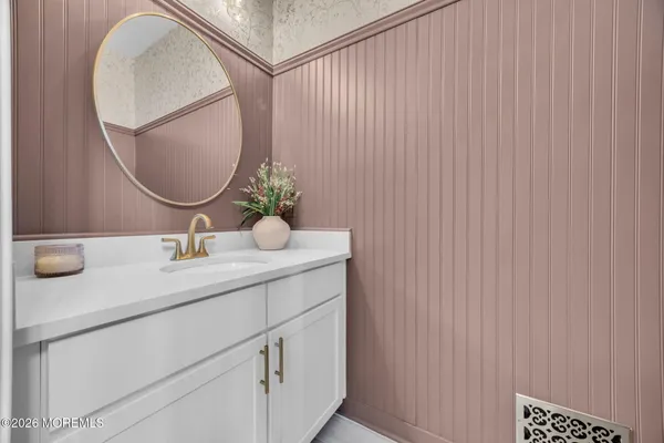 a bathroom with a sink vanity and a mirror