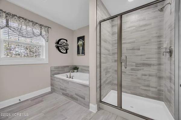 a bathroom with a bathtub and a shower