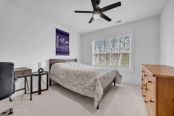 a bedroom with a bed dresser and a window