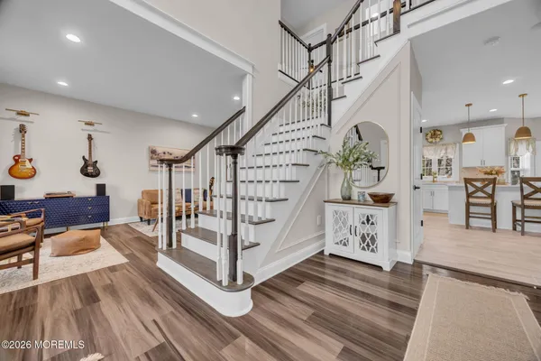 a view of entryway livingroom and hall with wooden floor