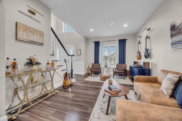 a living room with furniture and wooden floor