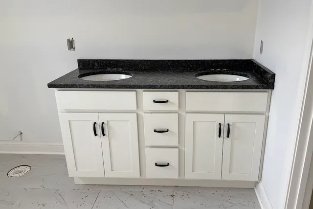a close view of a sink a stove and storage in a bathroom