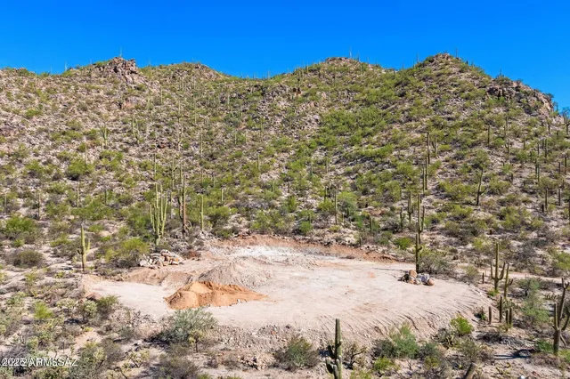 a view of a large building with mountains in the background