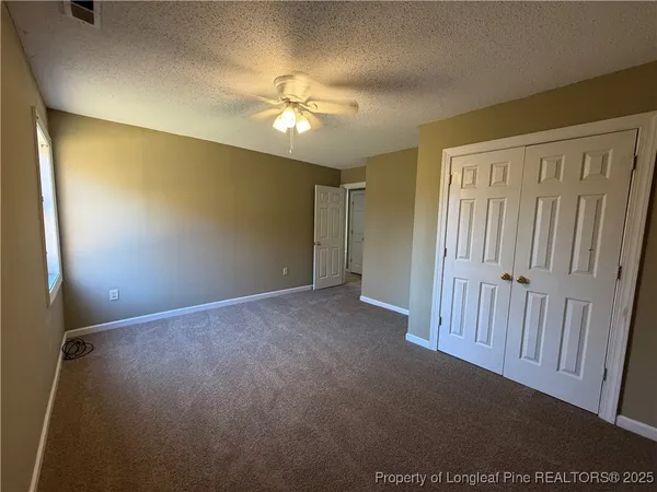 a view of a livingroom with a chandelier fan