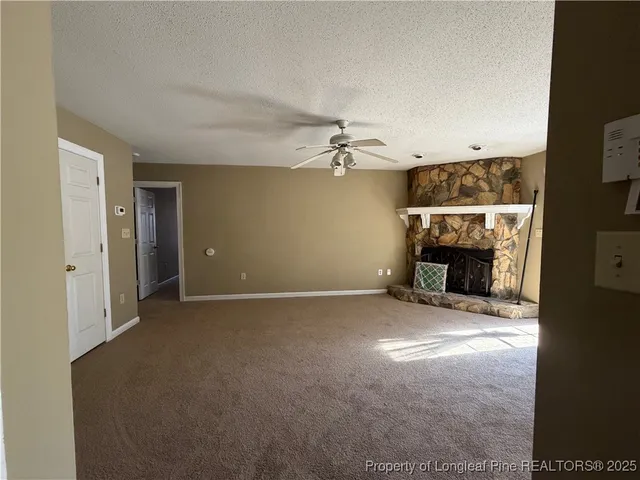 a view of empty room with fireplace