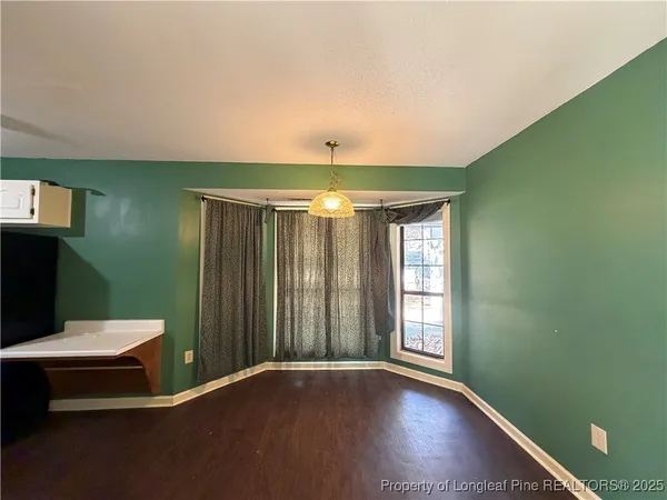 a view of room with window and hardwood floor