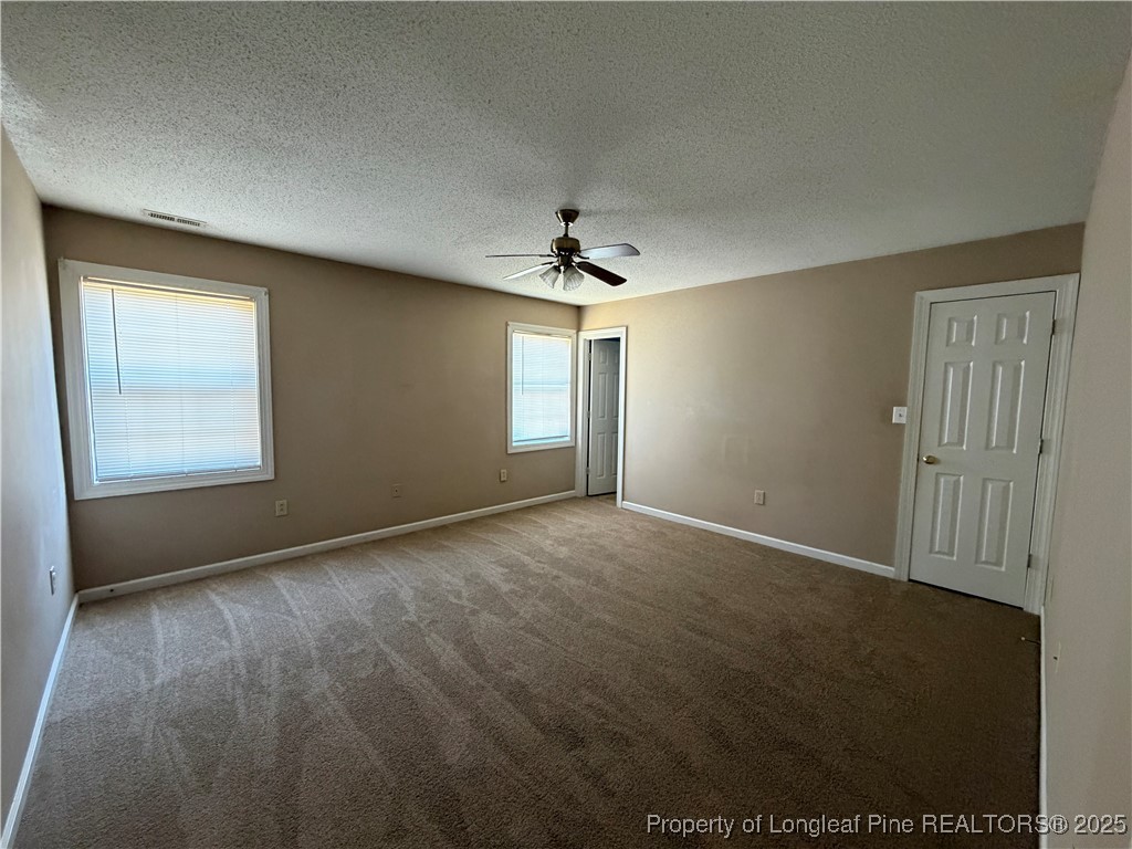 52 Montana Lane Spring Lake, NC 28390 - Photo 8 of 18 an empty room with windows and chandelier fan