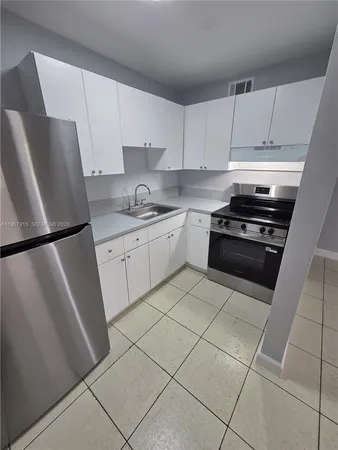 a kitchen with cabinets and appliances