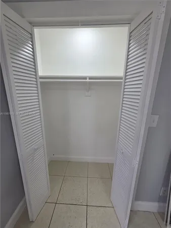 an empty room with wooden floor and a window