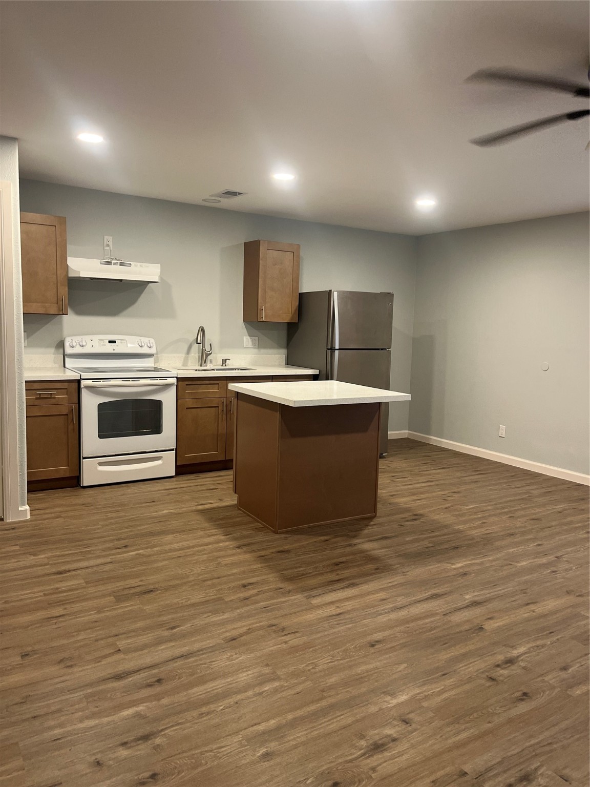 4624 Bell Street, Unit 2 Houston, TX 77023 - Photo 6 of 12 a large kitchen with stainless steel appliances granite countertop a stove a sink and a microwave