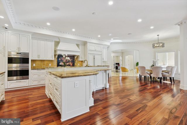a large kitchen with lots of counter top space and stainless steel appliances