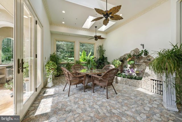 a view of a house with a porch and furniture