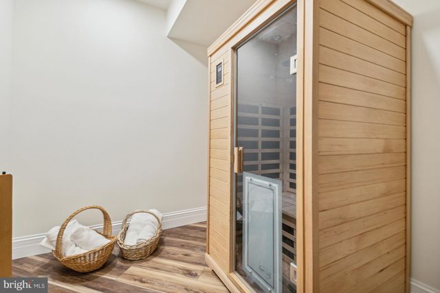 a view of a workspace with furniture and wooden floor