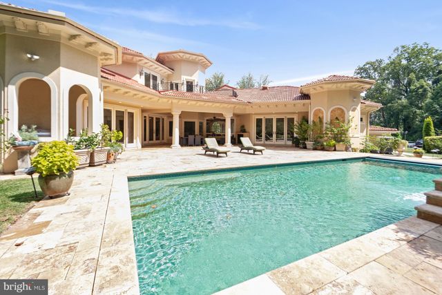 a front view of a house with garden and patio