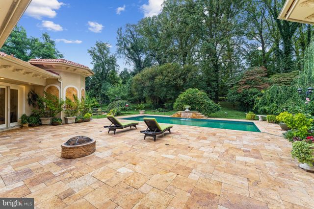 a view of patio with a table and chairs under an umbrella