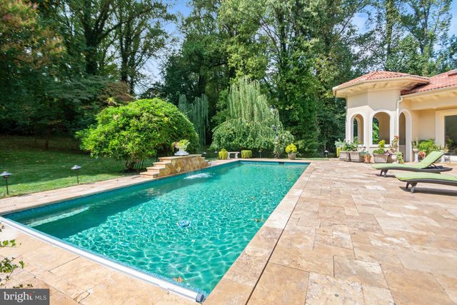 a view of a house with swimming pool and porch with furniture
