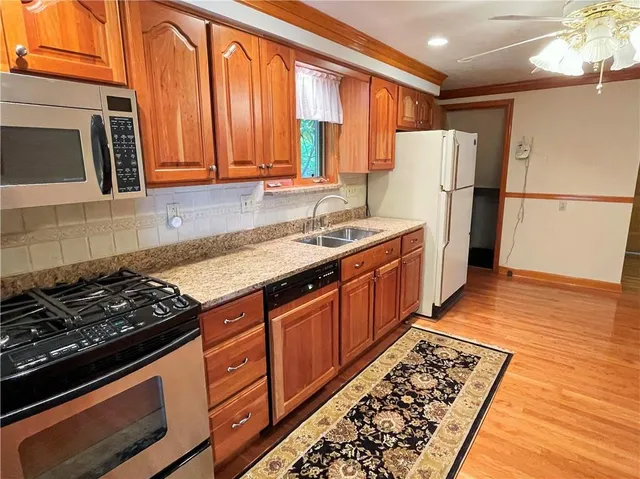 a kitchen with wooden cabinets and a stove top oven