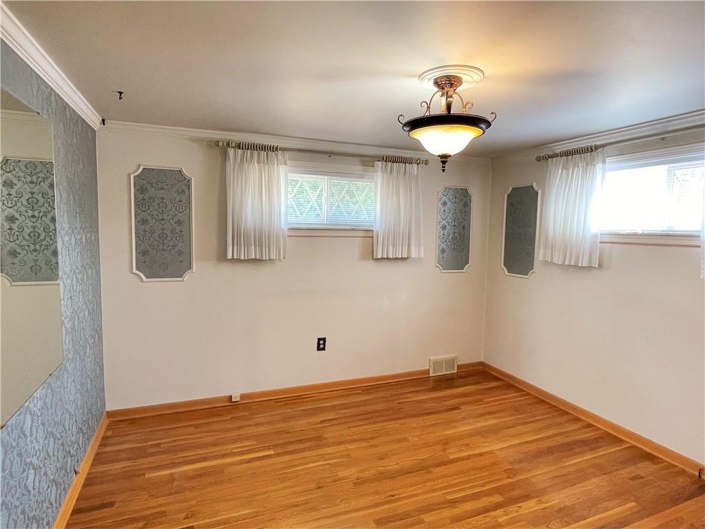2310 North Forest Grove Road Coraopolis, PA 15108 - Photo 15 of 50 a view of a room with wooden floor and chandelier