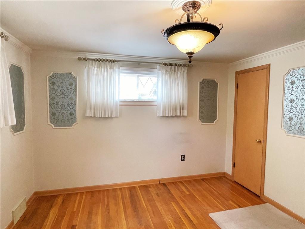 2310 North Forest Grove Road Coraopolis, PA 15108 - Photo 16 of 50 a view of a room with wooden floor and chandelier