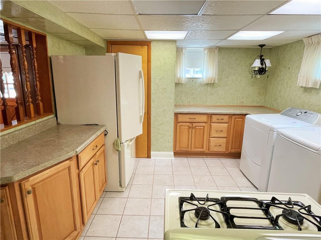 2310 North Forest Grove Road Coraopolis, PA 15108 - Photo 35 of 50 a kitchen with a sink a stove and refrigerator