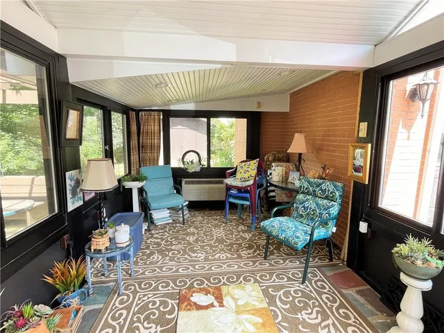 a living room with furniture and a floor to ceiling window