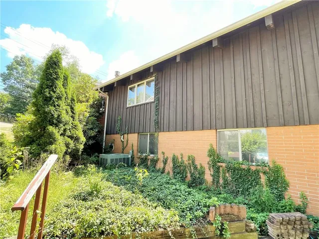 a view of house with backyard space and balcony