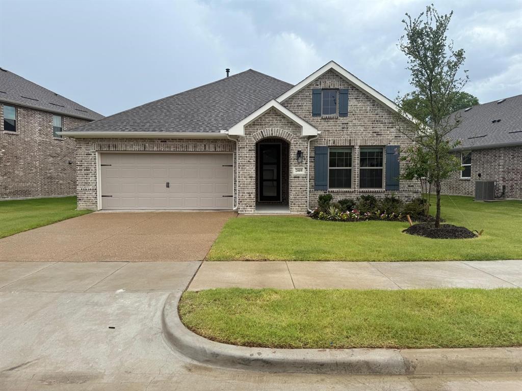 2009 Redtail Drive Melissa, TX 75454 - Photo 1 of 1 View of front of house with brick siding, concrete driveway, a garage, a front lawn, and roof with shingles