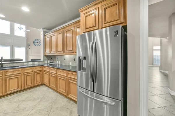 a bathroom with a granite countertop sink mirror vanity and toilet