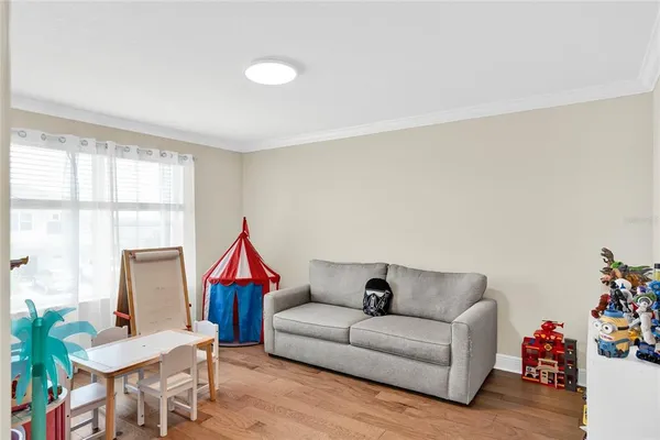a living room with furniture a rug and a window