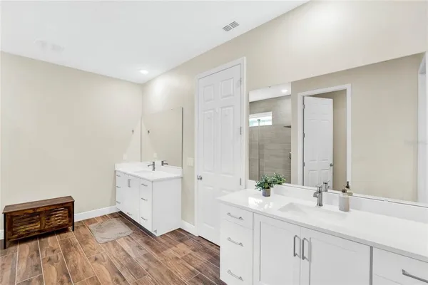 a bathroom with a double vanity sink and mirror