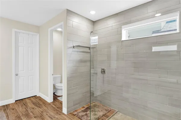 a bathroom with a shower and a sink