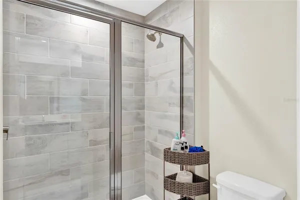 a bathroom with a toilet and a shower